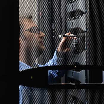 Worker attending to a server